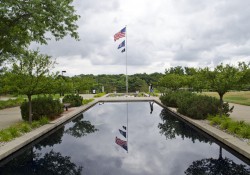 An American flag flying over the reflecting pools on KCC's North Avenue campus.