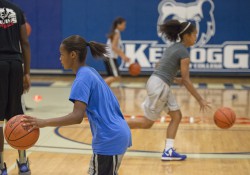 Youth basketball campers dribble during drills at a youth basketball camp in KCC's Miller Gym.