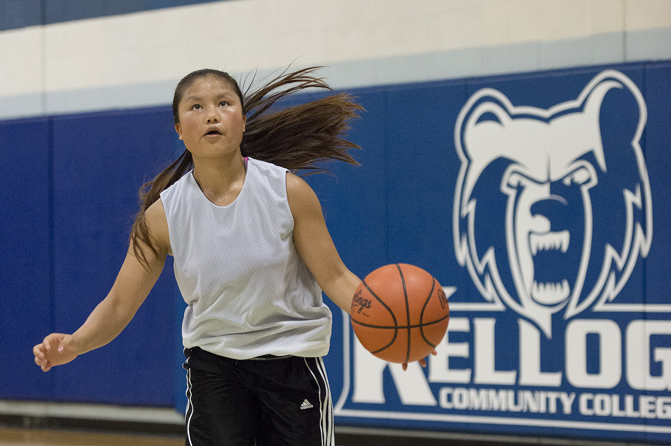 A basketball camp participant dribbles a basketball in the Miller Gym.