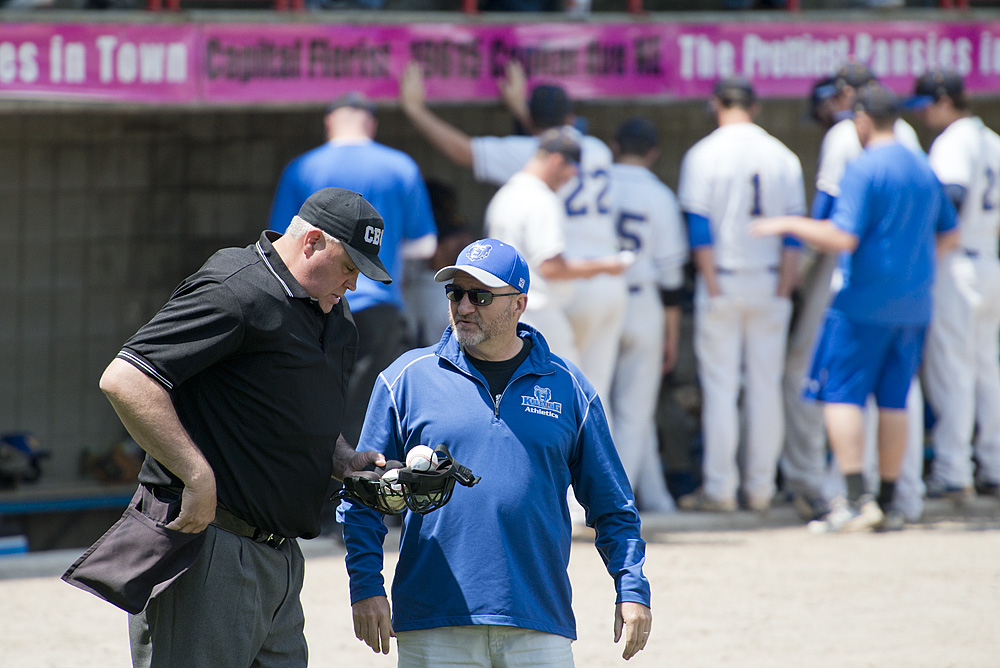 KCC Athletic Director Tom Shaw speaks to an umpire during a KCC baseball game at C.O. Brown Stadium.