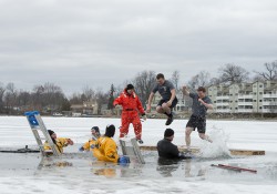 KCC students participate in the Battle Creek Polar Plunge by jumping into the water of a frozen lake.