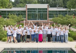 A group photo of the 2014 cohort of KCC Foundation Gold Key and Trustee scholars, taken outside in between the reflecting pools on campus in Battle Creek.
