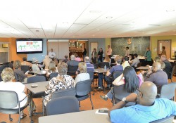 Jorge Zeballos, executive director of the KCC Center for Diversity and Innovation, addresses an audience during an open house in the Kellogg Room.