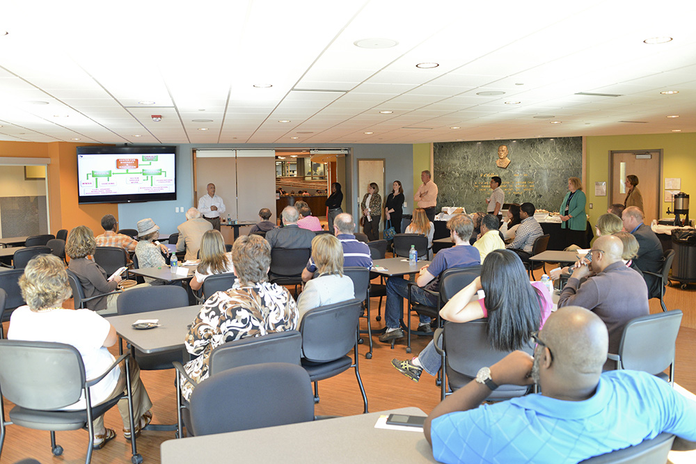 Jorge Zeballos, executive director of the KCC Center for Diversity and Innovation, addresses an audience during an open house in the Kellogg Room.