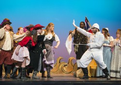 The cast of KCC's musical "The Pirates of Penzance" rehearses a scene on the stage of the Binda Performing Arts Center.