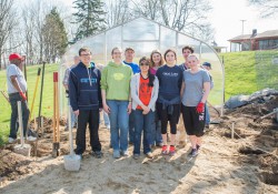 KCC students and employees pose for a group photo while working in the college's community garden on campus