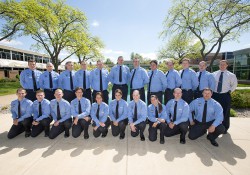 A group photo of KCC's 2014-15 Police Academy cadets, taken outside between the reflecting pools on the North Avenue campus in Battle Creek.