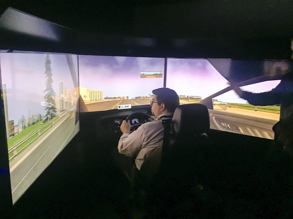 An EMS faculty member trains on a new driving simulator.