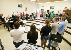 KCC choir members rehearse in a choir room on campus.