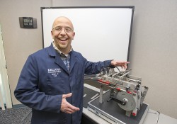 Shane Bresson, HVAC-R and Pipefitting instructor at Kellogg Community College, demonstrates one of the College’s new assessment trainers, which measures mechanical aptitude.