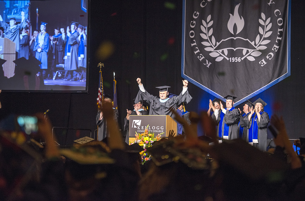 KCC President Mark O'Connell raises his hands to celebrate KCC's Class of 2016 during Commencement at Kellogg Arena.