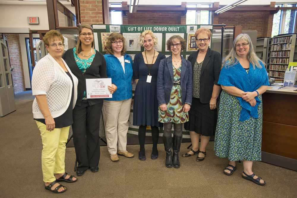 Pictured above, library staff pose with an organ donor quilt in the library following last year’s Michigan Libraries for Life event at KCC.