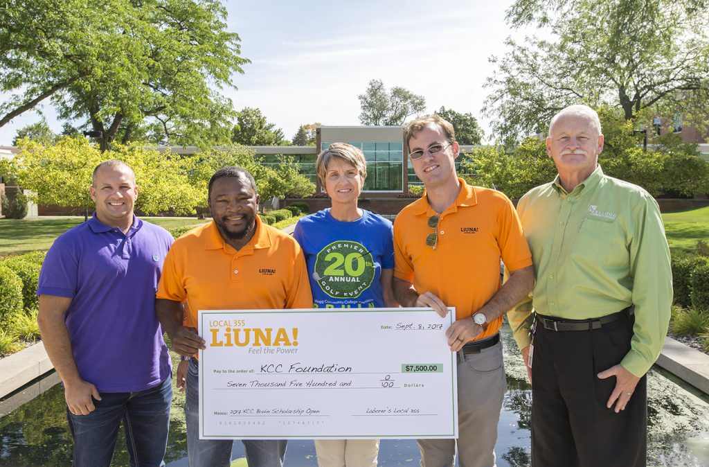 Representatives from Laborers' Local 355 present Teresa Durham, executive director of the KCC Foundation, and KCC President Mark O'Connell with a donation in support of student scholarships for the Bruin Open earlier this month. 