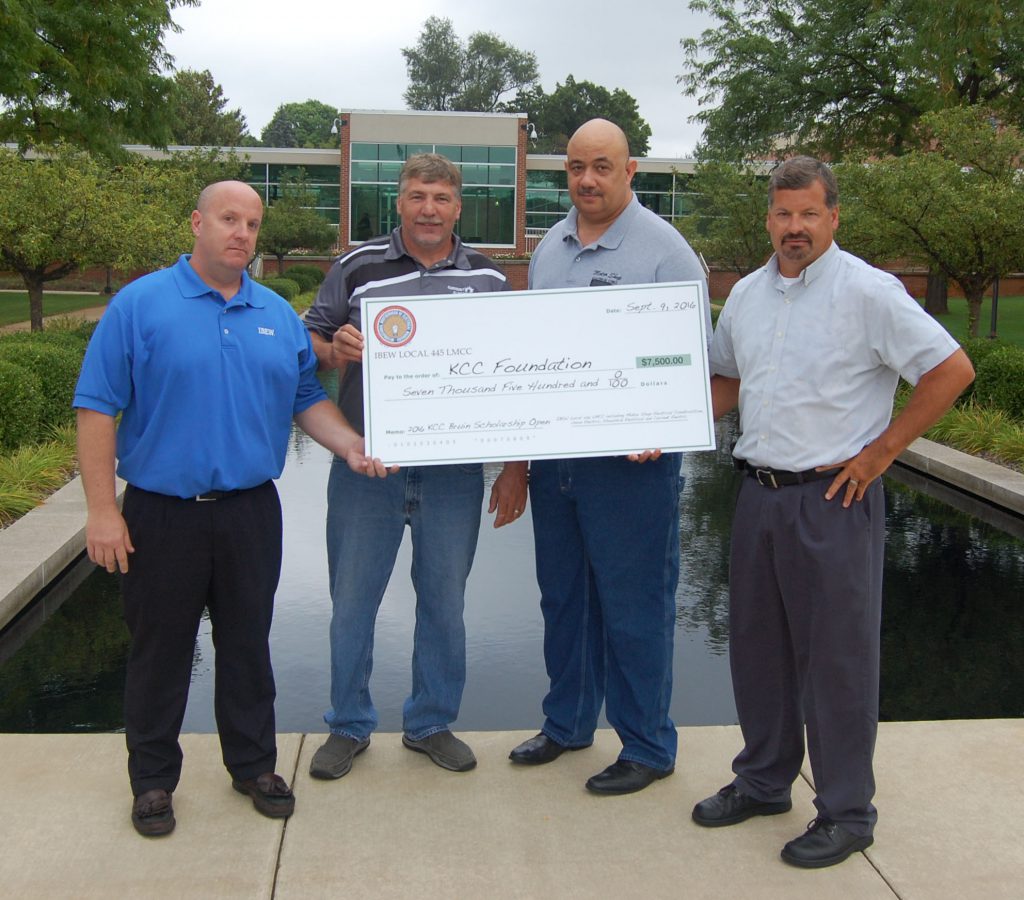 Representatives from IBEW Local 445 present a donation in support of student scholarships for the Bruin Open in 2016. The group made a similar donation for this year's event. 