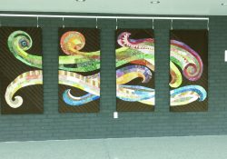 A photo of a colorful tapestry in the Binda lobby.