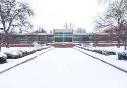 An exterior view of the main entrance to KCC's North Avenue campus in Battle Creek, covered in snow.
