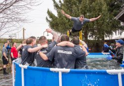 A KCC Police Academy cadet jumps into a pool during a polar plunge event in 2017.