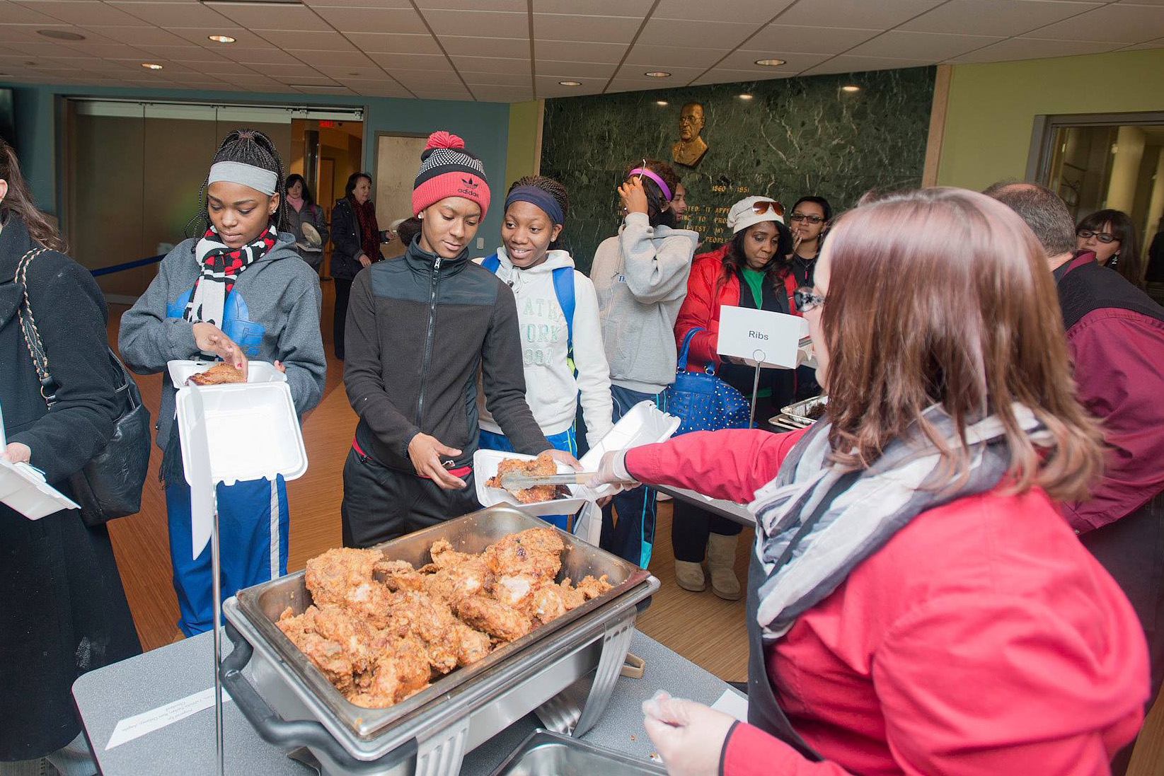 Attendees go through the food line at one of KCC's annual Soul Food Luncheon events.