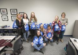 Dental Hygiene students and instructors pose with care packages they made for the homeless.