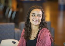 A female student smiles in the Student Center.