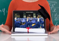 Closeup of a laptop screen showing an image of college graduates, along with a diploma and commencement cap.
