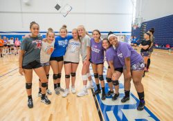 Youth volleyball camp participants pose for a group photo in the Miller Gym.