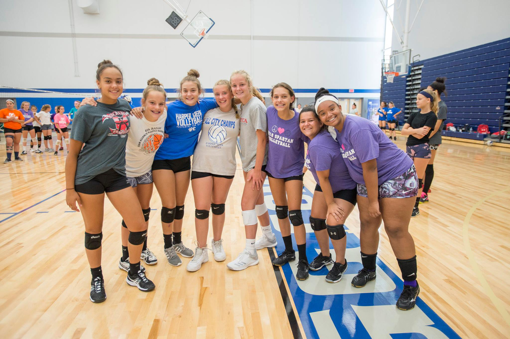 Youth volleyball camp participants pose for a group photo in the Miller Gym.