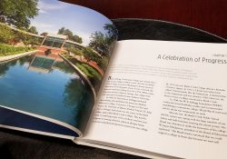 A decorative image showing an interior spread of the book "Always a Bruin," including a full page photo of the reflecting pools on the North Avenue campus.