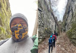 A collage of two pictures including one of Drew Hutchinson wearing a face mask and another of a group of people hiking through a canyon.