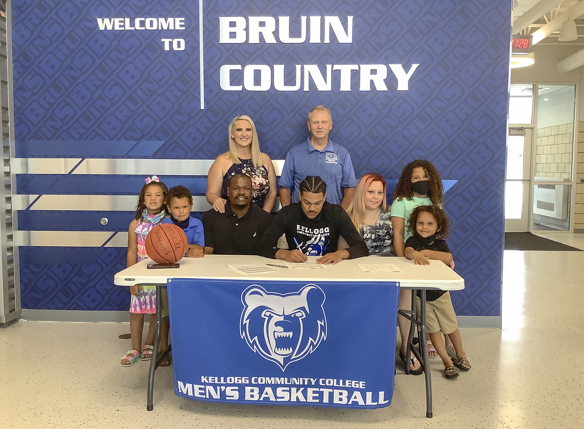 Keelan Stricklen signs his Letter of Intent at KCC while surrounded by family members.