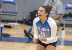 A volleyball player celebrates after scoring a point.