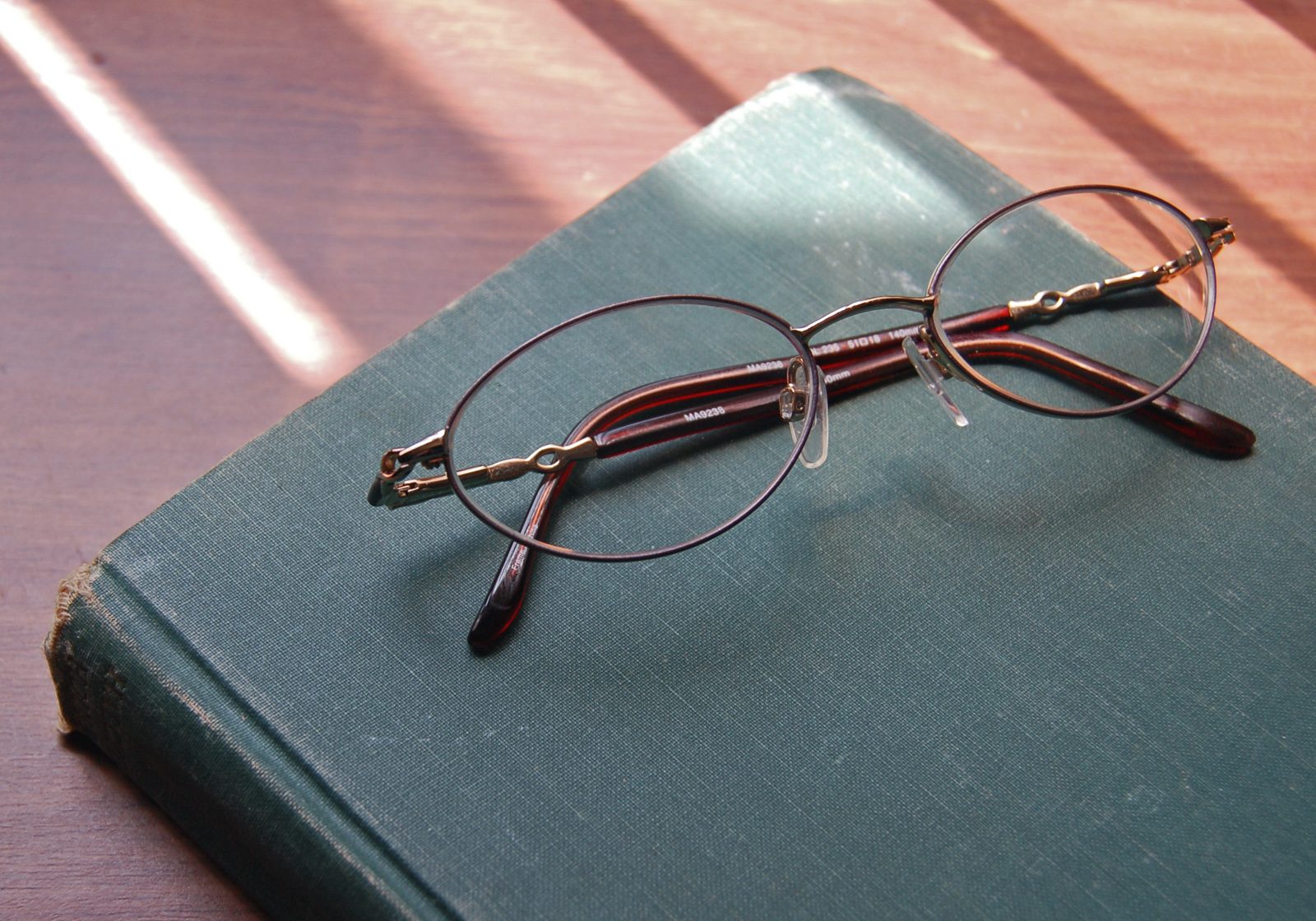 Glasses resting on a closed book
