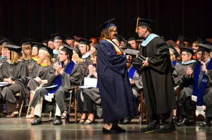 KCC President Dr. Dennis Bona hands out the first diploma during commencement last spring.