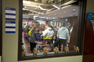 The line to check out at the Bruin Bookstore reflected in an interior window.