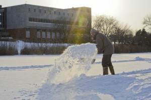 Peter Ingalls, a founder and former marketing director of the Music Center on KCC's North Avenue campus, clears snow to make space for skating on Spring Lake last month.