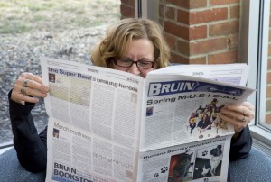 Computer Lab Technician Shari Deevers reads the latest issue of the Bruin student newspaper.