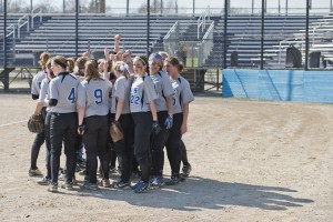 The softball team meets on the field before their second home game against Ancilla on Monday.