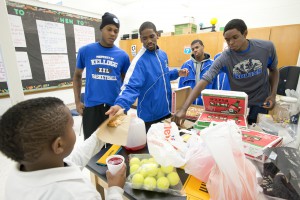 Members of KCC's men's basketball team serve kids at Dudley STEM School in Battle Creek.