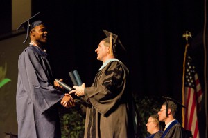 Darius Holman, left, receives his diploma from KCC President Dr. Dennis Bona during last week's commencement ceremony. Visit KCC's Facebook page for more images from commencement.