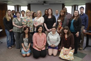 SERV 299 students, instructors and community partners pose before a presentation of student projects this morning.