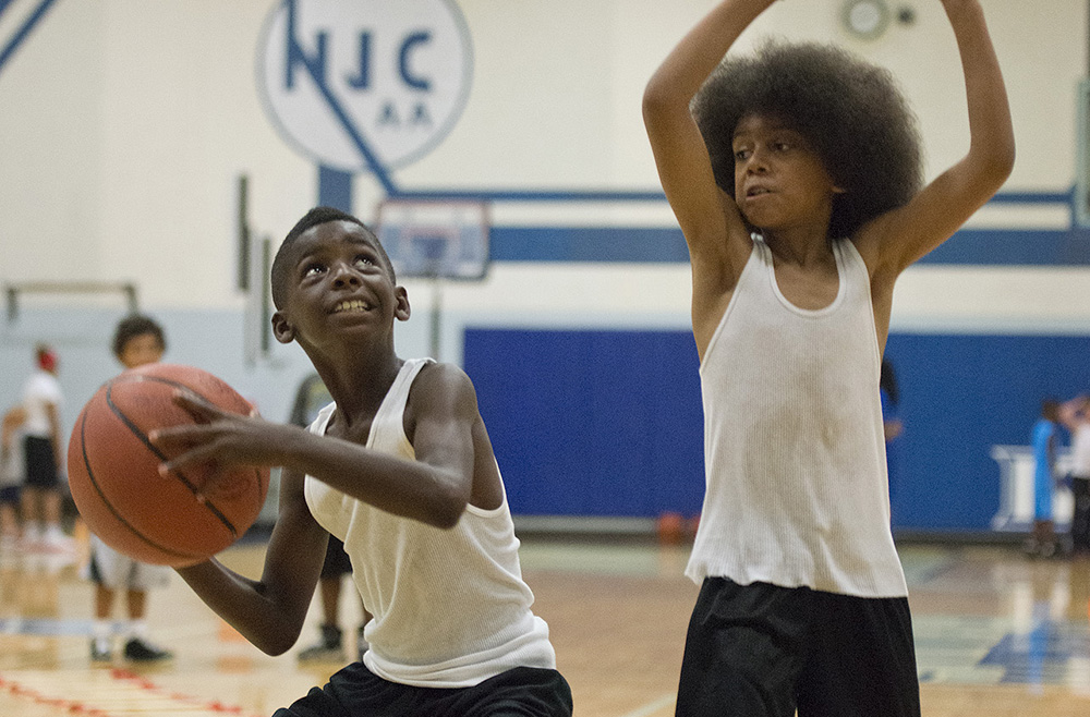 Kids participate in a summer youth basketball camp at KCC's Miller Gym