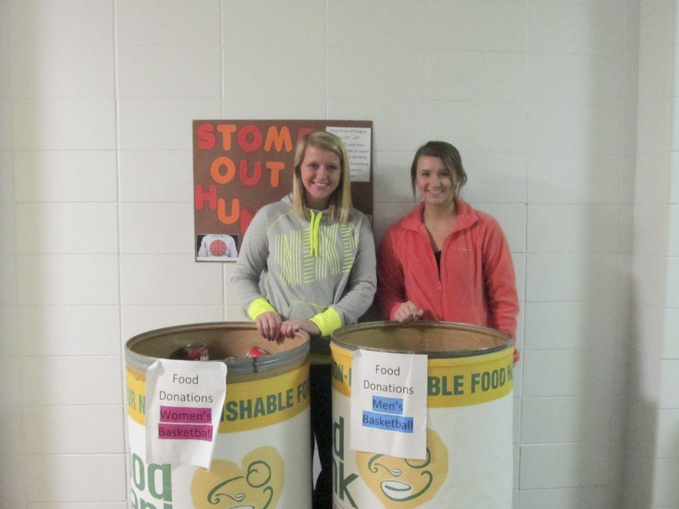 KCC student-athletes pose with food donated for the Food Bank.