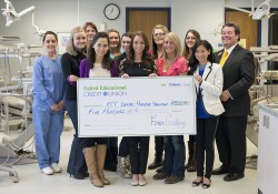 Dental Hygiene students pose with a check presented by United Educational Credit Union's Scott White