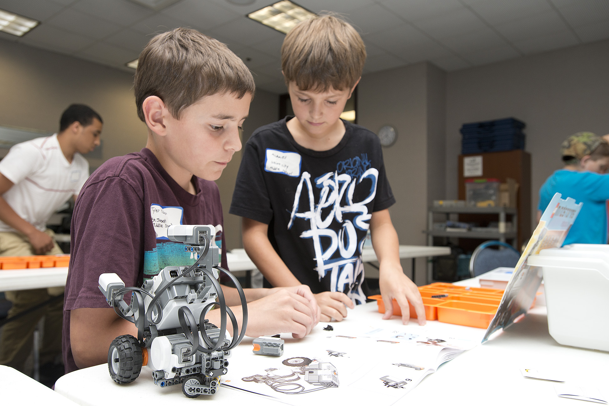 Students work on a robot during a camp at the RMTC.