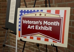 A sign for the Veteran's Month Art Exhibit.