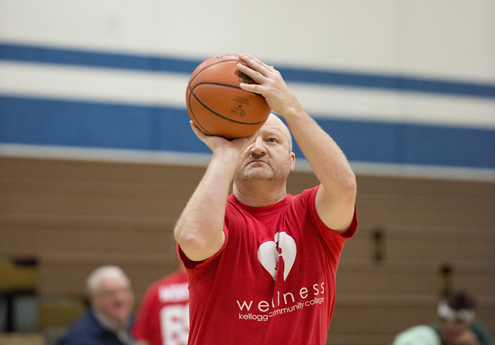Athletic Director Tom Shaw sets up a shot during a charity basketball game at the Miller Gym.