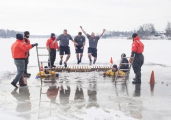 KCC Police Academy cadets jump into the waters of a frozen lake during the 2015 Battle Creek Polar Plunge.