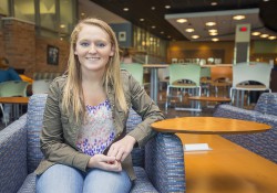 A female scholarship recipient poses in the Student Center on the North Avenue campus