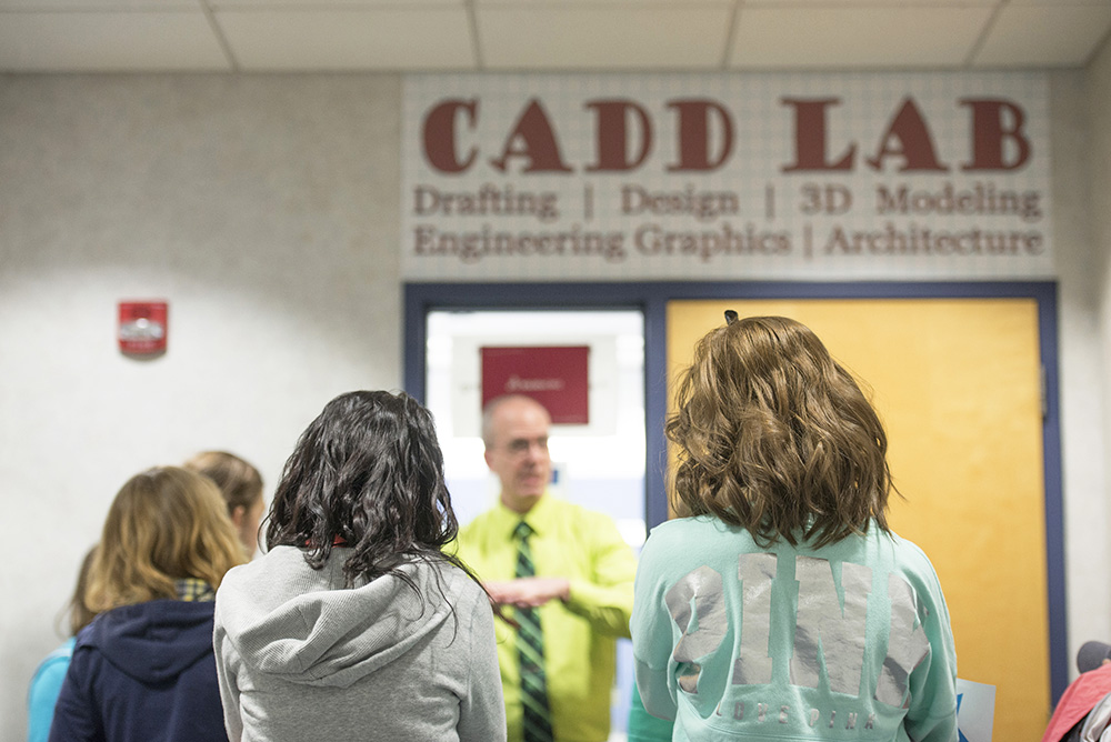 Female Union City Middle School students listen to KCC CAD professor Randy Kopf talk about the program in the hall outside the KCC CAD Lab during the College's Nontraditional Fair on Friday, March 6.