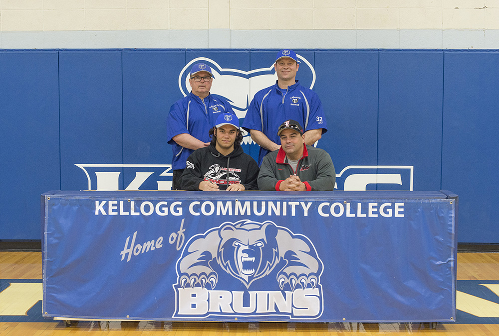 New KCC baseball signee Joseph Nate poses in a KCC signing photo with KCC baseball coaches and some family members
